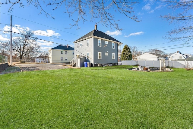 rear view of property featuring a yard