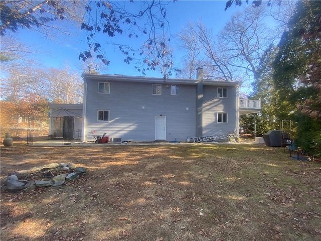 rear view of house featuring a chimney