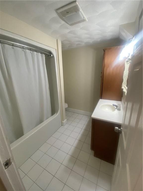 bathroom featuring shower / tub combo, baseboards, toilet, tile patterned flooring, and vanity