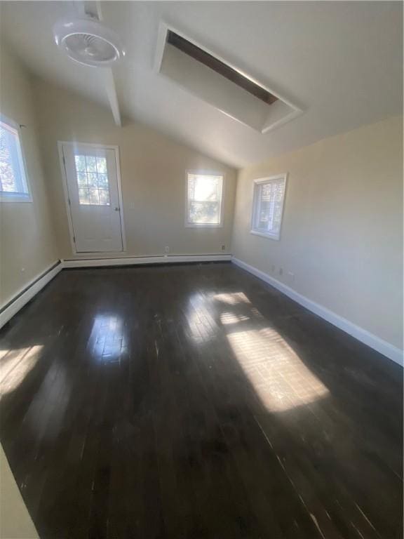 unfurnished room with lofted ceiling, dark wood-type flooring, and baseboards