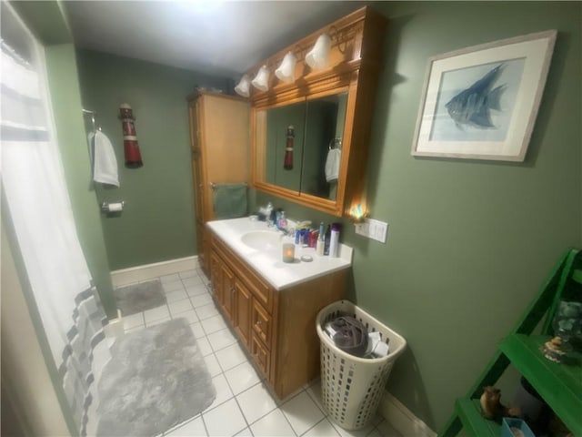 full bathroom with a shower with curtain, tile patterned flooring, vanity, and baseboards