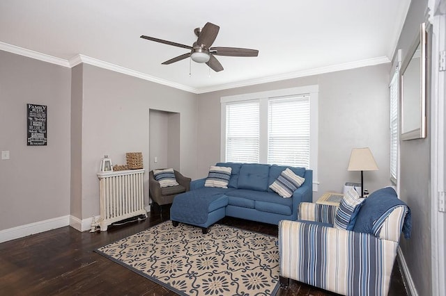 living room with crown molding, ceiling fan, and dark wood-type flooring