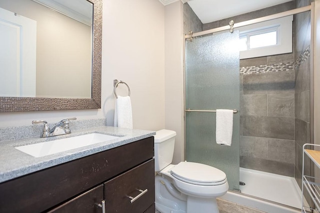 bathroom featuring vanity, toilet, an enclosed shower, and crown molding