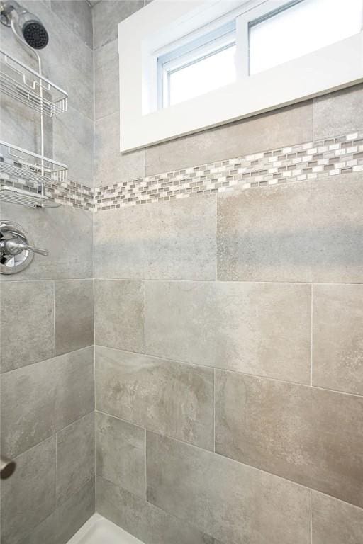 bathroom with tiled shower