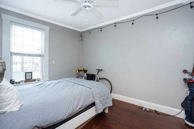 bedroom featuring dark hardwood / wood-style floors, ceiling fan, and ornamental molding