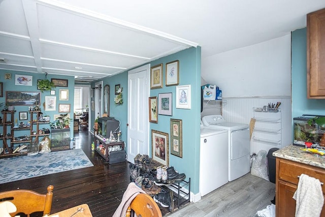 clothes washing area featuring separate washer and dryer and light hardwood / wood-style flooring