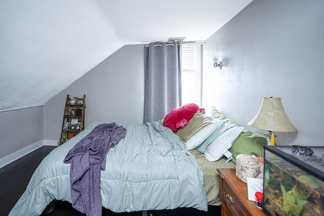 bedroom featuring lofted ceiling and hardwood / wood-style flooring