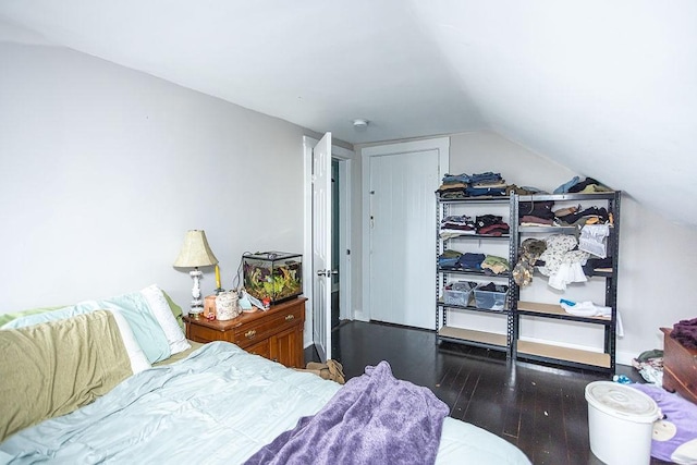 bedroom featuring lofted ceiling and dark wood-type flooring