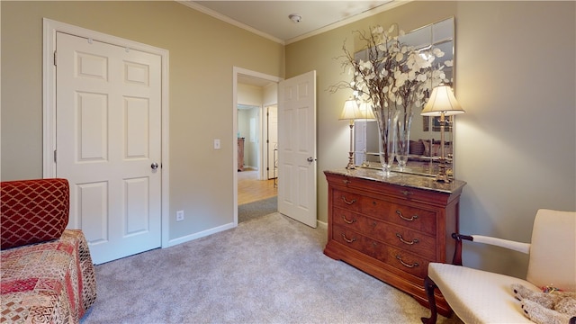 sitting room featuring light colored carpet and crown molding