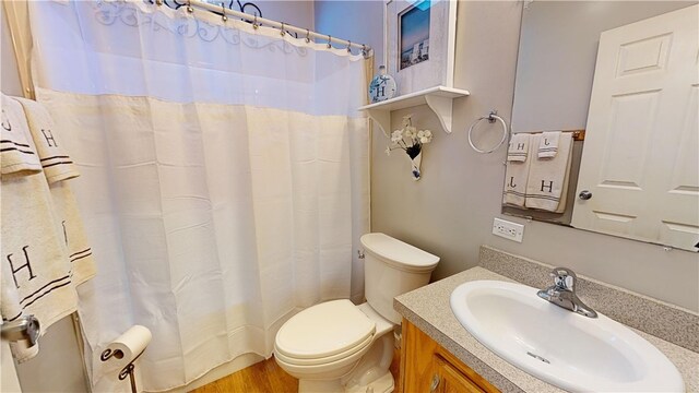 bathroom featuring hardwood / wood-style flooring, vanity, and toilet