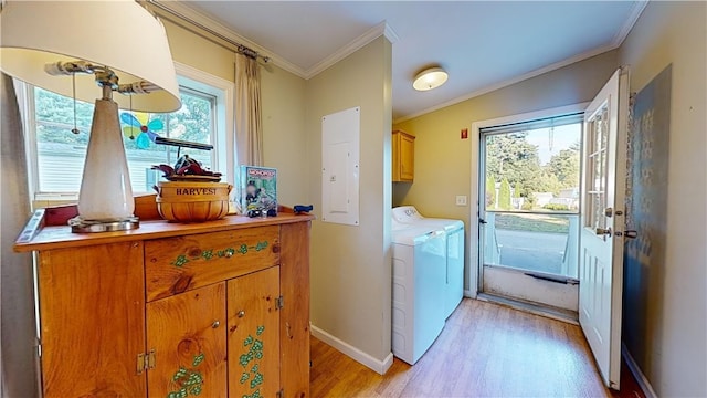 washroom with cabinets, washing machine and dryer, electric panel, light hardwood / wood-style floors, and ornamental molding