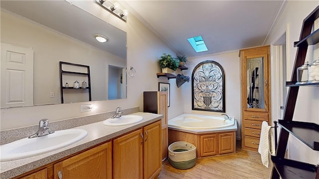 bathroom featuring a washtub, vanity, lofted ceiling with skylight, crown molding, and wood-type flooring