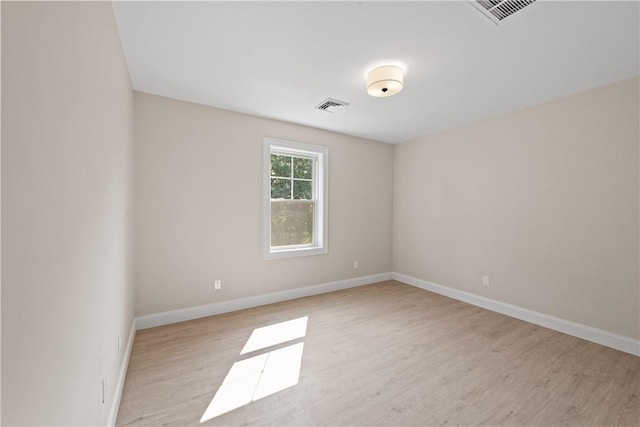 spare room with light hardwood / wood-style floors