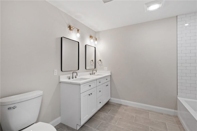 bathroom with tile patterned floors, vanity, and toilet