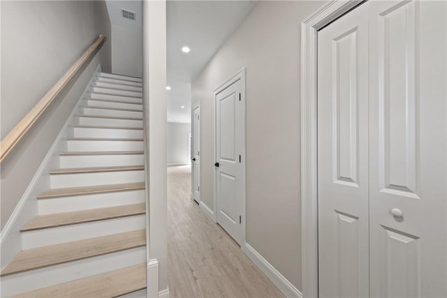 stairs with hardwood / wood-style flooring