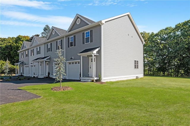 view of front facade with a garage and a front lawn