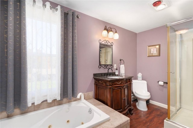 full bathroom featuring hardwood / wood-style floors, vanity, separate shower and tub, toilet, and a healthy amount of sunlight