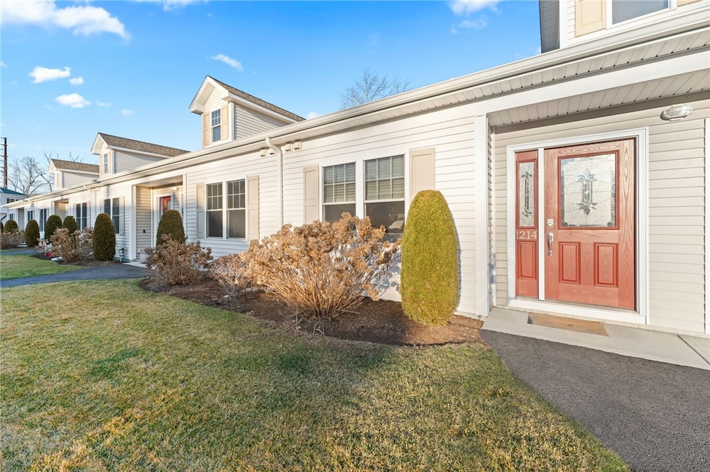 doorway to property with a yard