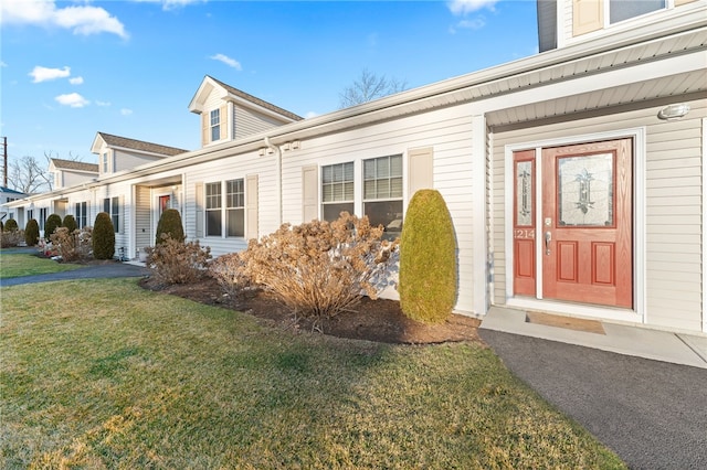 doorway to property with a yard