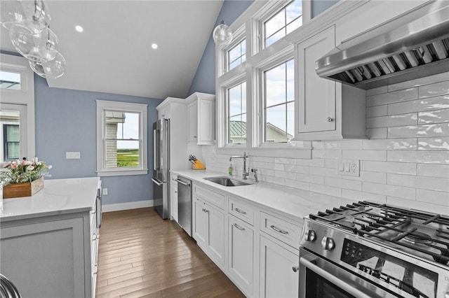 kitchen featuring sink, ventilation hood, vaulted ceiling, white cabinets, and appliances with stainless steel finishes