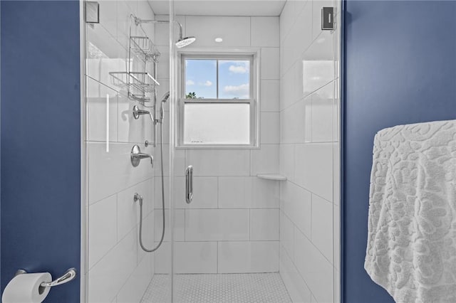 bathroom with a shower with door