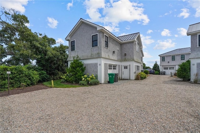 rear view of property with a garage