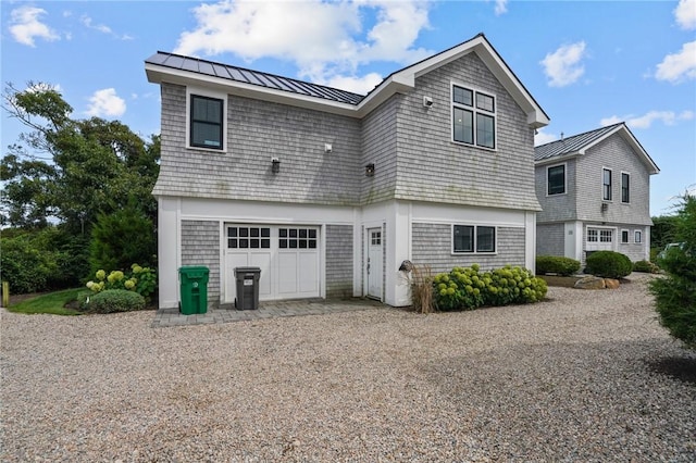 back of house with a garage