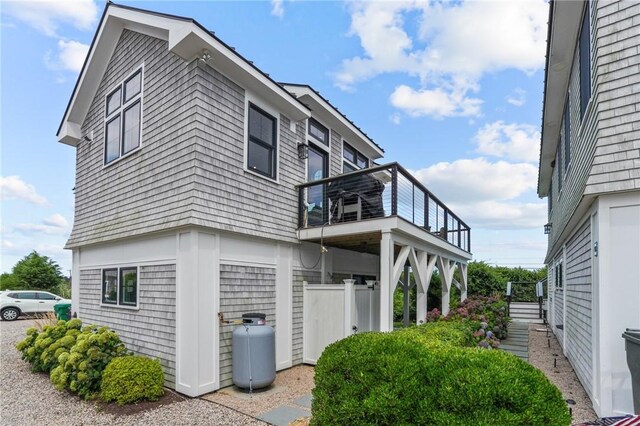 view of side of home featuring a balcony