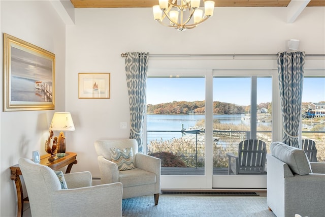 sitting room featuring beam ceiling, a water view, a wealth of natural light, and a chandelier