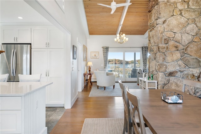 dining area with beamed ceiling, high vaulted ceiling, light hardwood / wood-style floors, wood ceiling, and ceiling fan with notable chandelier