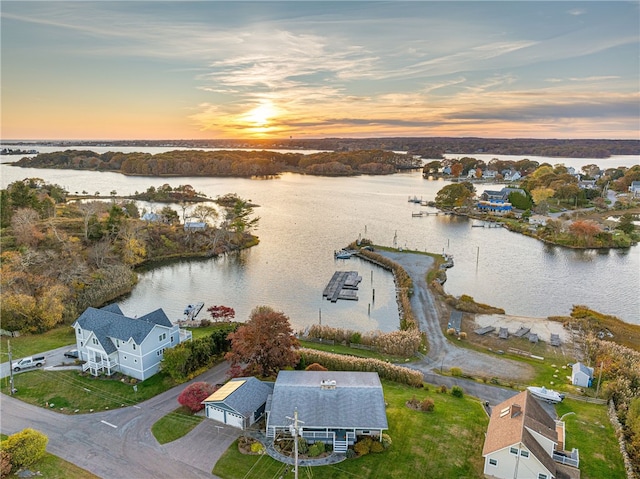 aerial view at dusk with a water view