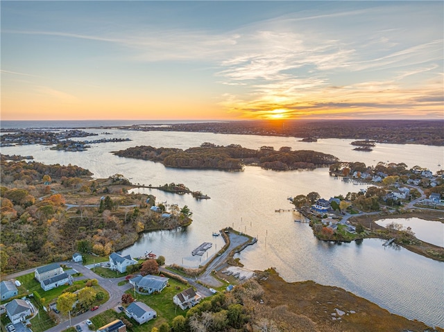 aerial view at dusk with a water view