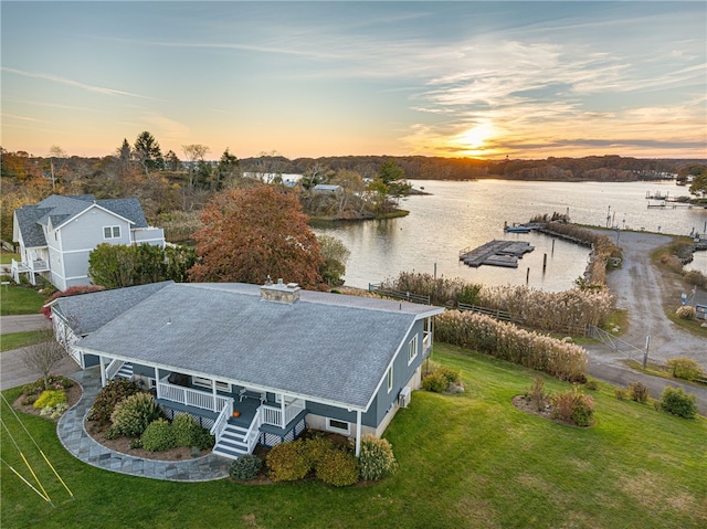 aerial view at dusk with a water view