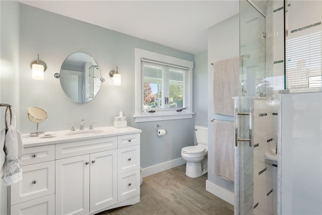 bathroom with toilet, vanity, and walk in shower