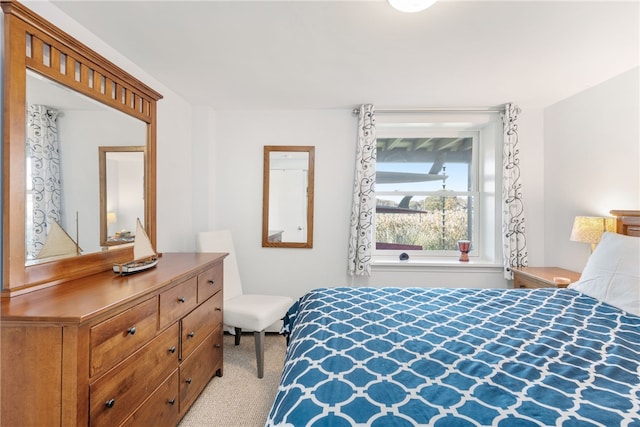 bedroom featuring light colored carpet