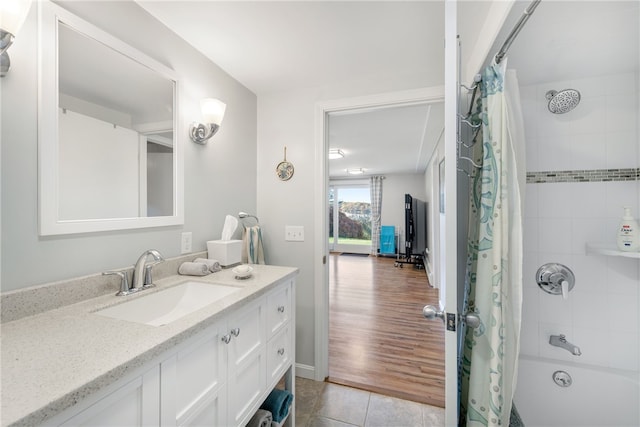 bathroom featuring shower / bath combo with shower curtain, vanity, and tile patterned flooring