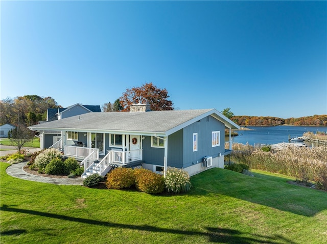 view of front of house featuring a water view, covered porch, and a front yard