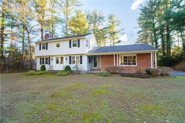 view of front of house featuring a front yard and french doors