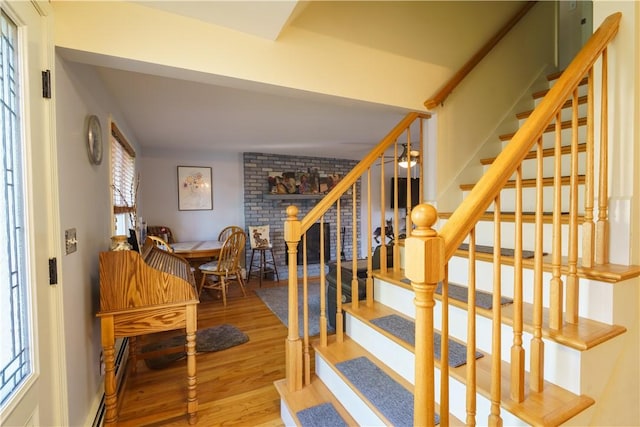 staircase with hardwood / wood-style floors