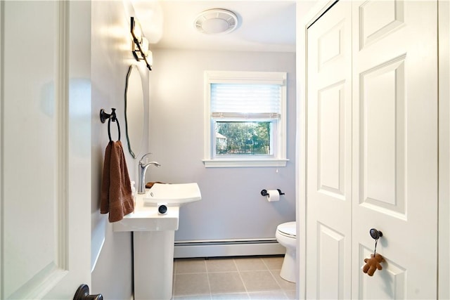 bathroom featuring toilet, tile patterned flooring, and a baseboard heating unit