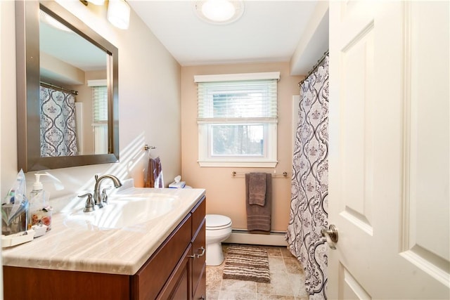 bathroom featuring vanity, toilet, and a baseboard heating unit