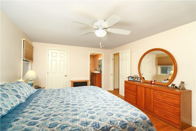 bedroom with hardwood / wood-style floors and ceiling fan