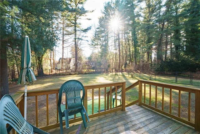 wooden deck featuring a yard