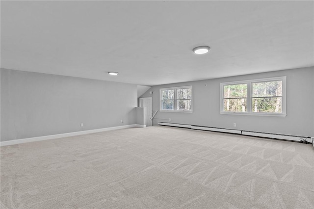 basement featuring a baseboard radiator and light carpet