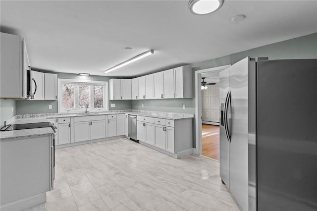 kitchen with white cabinetry, ceiling fan, appliances with stainless steel finishes, and sink