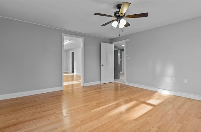 empty room featuring light hardwood / wood-style flooring and ceiling fan