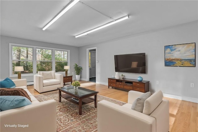 living room featuring baseboard heating and light wood-type flooring