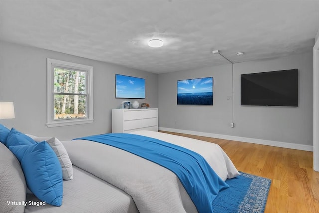 bedroom with hardwood / wood-style floors