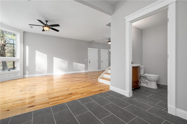 interior space with ceiling fan and dark hardwood / wood-style flooring