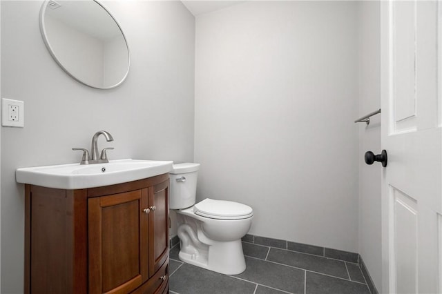 bathroom featuring tile patterned flooring, vanity, and toilet